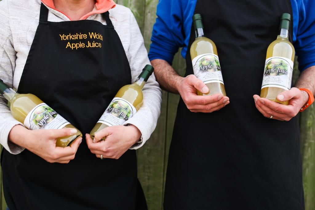 Apple Juice bottles in our hands Apple Juice bottles in our hands